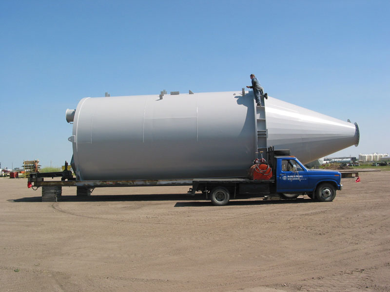 conical-shape hopper silos blasting paint white transportation