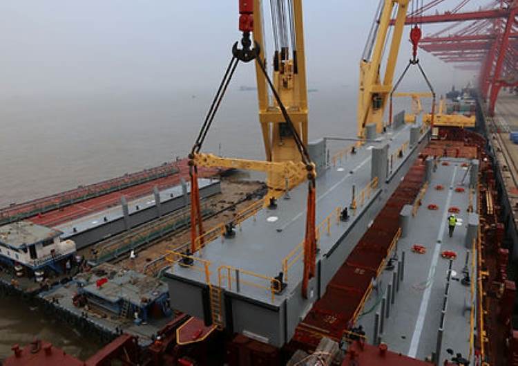 Loading of the 52 metre length pontoon on to the vessel