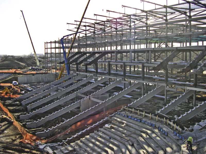 Steel raking beams support the top level of seating and half of the lower level